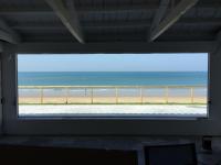 a window view of the beach from a house at La Torre Verde, villa a pie de playa in Inmaculada