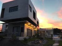a white house with a sunset in the background at Taitung Jia Lulan Tribal in Taitung City