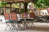 a group of chairs sitting at a table in a patio at Hotel Oberwirt in Obing