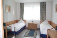 a small room with a bed and a window at RIESENjunior Hanau by Trip Inn in Hanau am Main