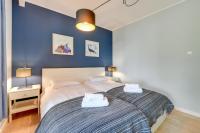 Łóżko lub łóżka w pokoju w obiekcie Gdansk Comfort Apartments Bursztynowa