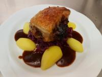 a white plate with a piece of cake and sauce at Hotel Am Fleesensee in Malchow