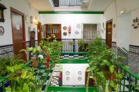 a hallway filled with plants and flowers at Pensión San Benito Abad in Seville