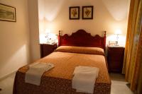 a bedroom with a bed with two towels on it at Pensión San Benito Abad in Seville