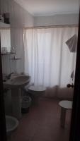 a bathroom with a sink and a toilet and a shower curtain at Hotel Catalán Puerto Real in Puerto Real