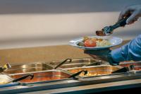 a person holding a plate of food in a kitchen at Cassidys Hotel in Dublin
