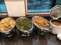 a group of four pots of food on a table at Abbo Hotel in Tainan