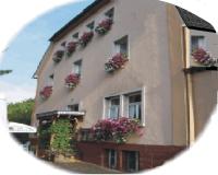 a building with flower boxes on the side of it at Pension zum Saale Blick in Bad Kissingen