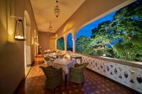 a restaurant with tables and chairs and a large window at Roça Sundy - Principe Collection in Santo António