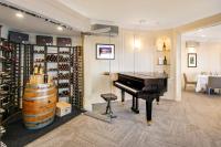 een kamer met een piano en een wijnkelder bij Villa Eyrie Resort in Malahat