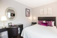 a bedroom with a large bed and a mirror at Le Figuier in Ivry-sur-Seine