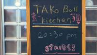 a chalkboard with writing on it in front of a window at On My Way Jiufen Youth Hostel in Jiufen