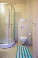a bathroom with a toilet and a glass shower at Stop Hotel in Braşov