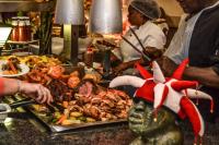 ein Buffet mit einem Teller Essen auf dem Tisch in der Unterkunft Gooderson Drakensberg Gardens Golf & Spa Resort in Drakensberg Garden