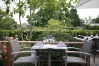 uma mesa com cadeiras e copos num pátio em Koru Hôtel & Private Wellness em Autre-Église