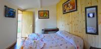 a bedroom with a large bed in a room at Pousada Sino dos Ventos in Campos do Jordão