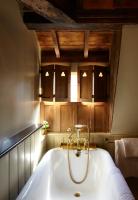 a bath tub in a bathroom with wooden cabinets at The Rookery in London