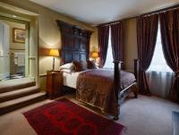 a bedroom with a bed and a large window at The Rookery in London