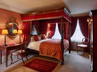 a bedroom with a canopy bed and a table and chairs at The Rookery in London