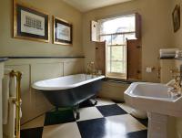 a bathroom with a tub and a toilet and a sink at The Rookery in London