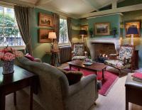 a living room with a couch and a fireplace at The Rookery in London