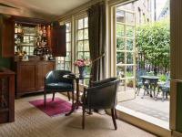 a room with a table and chairs and a window at The Rookery in London