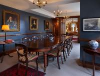 a dining room with a wooden table and chairs at The Rookery in London
