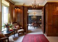 a hallway with a dining room with a table and chairs at The Rookery in London