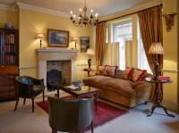 a living room with a couch and a fireplace at The Rookery in London