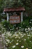 a sign in the middle of a field of flowers at Pousada Colina Da Neve in São Joaquim