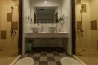 a bathroom with two sinks and a shower at Sleeping Boot Hostel in Hualien City