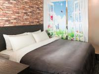 a bedroom with a bed and a brick wall at E-House Hotel in Taipei