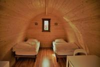 two beds in a small room with a window at Camping Bissen in Esch-sur-Sûre
