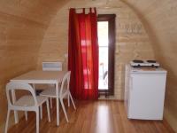 a kitchen with a table and chairs and a window at Camping Bissen in Esch-sur-Sûre