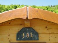 a number on the side of a wooden building at Camping Bissen in Esch-sur-Sûre