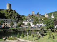 a town with a river and castles on a hill at Camping Bissen in Esch-sur-Sûre