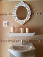 a bathroom with a sink and a mirror on the wall at Etyek Rustic Home in Etyek