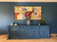 a blue cabinet in a room with a painting on the wall at Pousada Casa do Catavento in Búzios