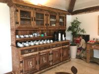 a wooden cabinet with cups on it in a room at Pousada Casa do Catavento in Búzios