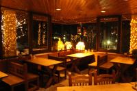 a restaurant with tables and chairs and christmas lights at Lodge Scole in Zao Onsen