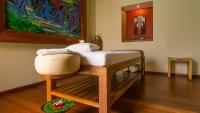 a platform bed in a room with a painting at Qunci Villas Resort in Senggigi