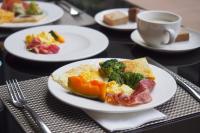 a table with plates of food and a cup of coffee at Fuli Hot Spring Resort in Yuchi