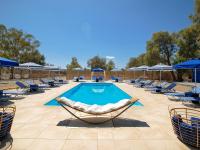 a pool with chaise lounge chairs and a swimming pool at Thalasea Kimolos - Θalasea - PS Rental in Kimolos