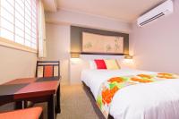 a hotel room with two beds and a table and a desk at Kyoto Inn Gion The Second in Kyoto