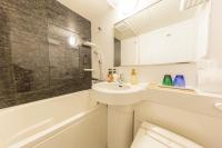 a white bathroom with a sink and a toilet at Kyoto Inn Gion The Second in Kyoto