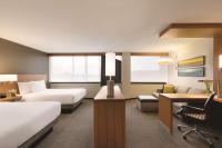 a hotel room with two beds a desk and a couch at Hyatt Place Chicago O'Hare Airport in Rosemont