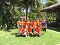 a group of people in orange shirts posing for a picture at Peppercorn Beach Resort in Phú Quốc