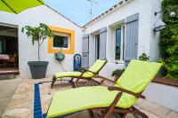 two chairs and a table on a patio at Les Yeux Bleus Bed &amp; Breakfast in Noirmoutier-en-l&#39;lle