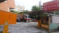 a truck parked in a parking lot next to a building at Sanduo Hotel in Kaohsiung