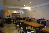 a dining room with wooden tables and chairs at Hotel Leisure Beitou in Taipei